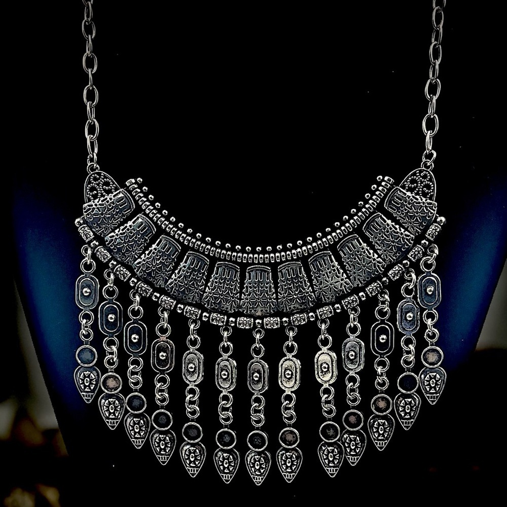 Elegant silver-tone necklace and earrings set with triple ring pendant.​